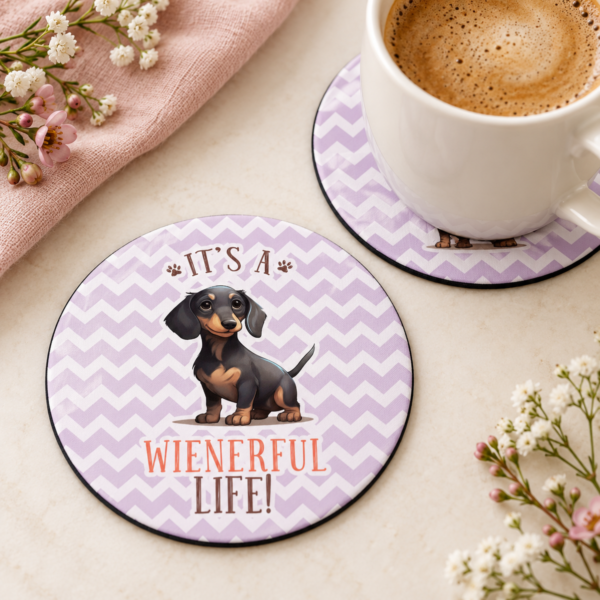 It's a Wienerful Life round coaster set of two with thin black rubber backing