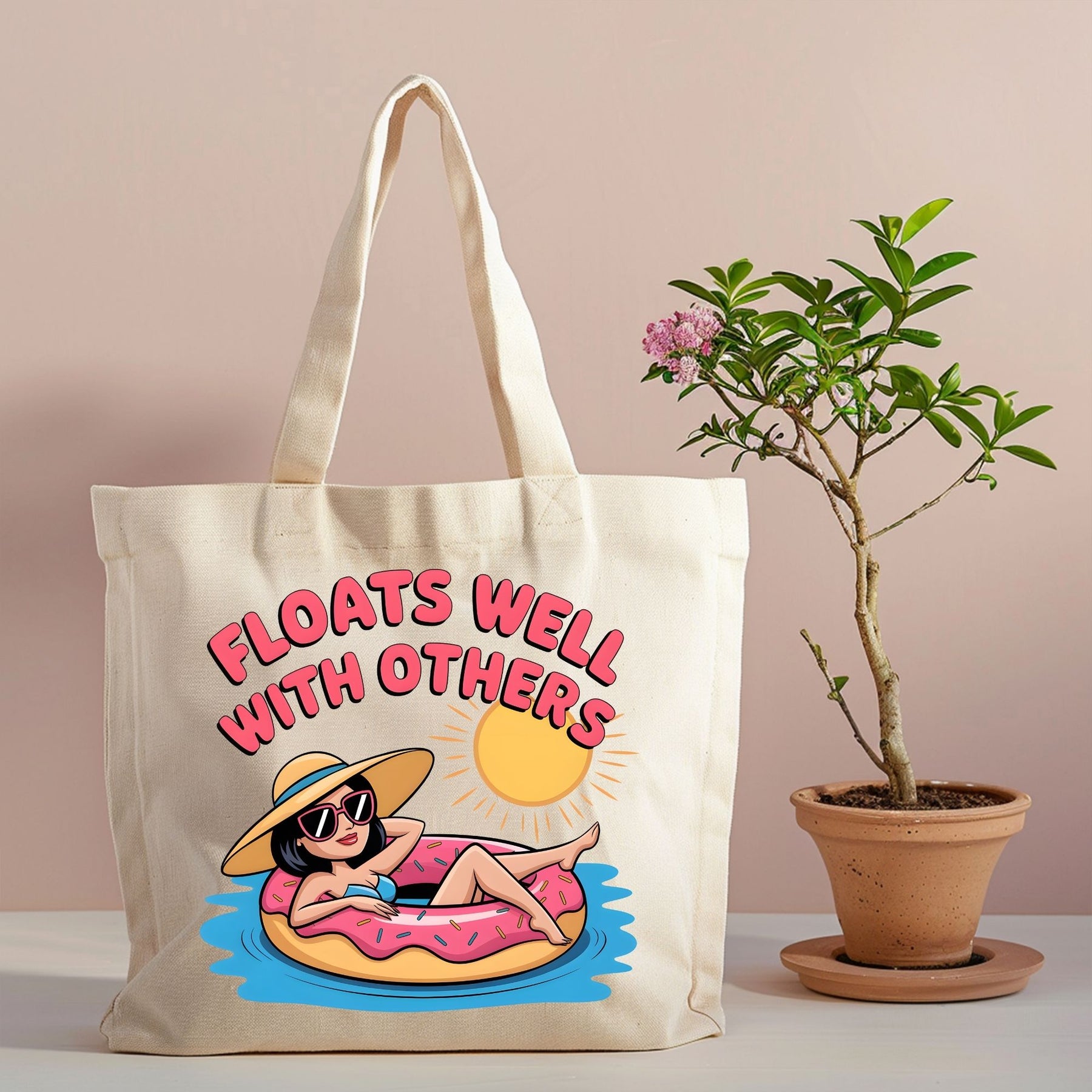 Floats Well With Others canvas tote with pink pool float design