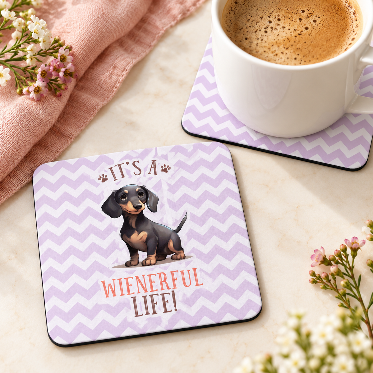 It's a Wienerful Life square coaster set of two with thin black rubber backing