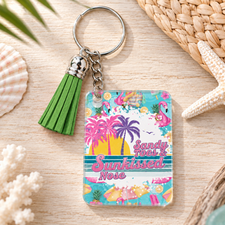 Sandy Toes Sunkissed Nose keychain with green tassel