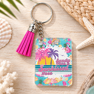 Sandy Toes Sunkissed Nose keychain with hot pink tassel