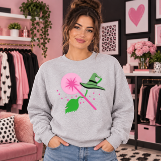 Pink wand and witch essentials design on light grey crewneck model