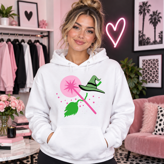 Pink wand and witch essentials design on white hoodie model